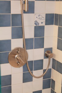 The shower valve (Made in USA) is thermostatic which allows for perfect control of flow and temperature. The top handle is for the shower and the bottom handle is for the tub spout